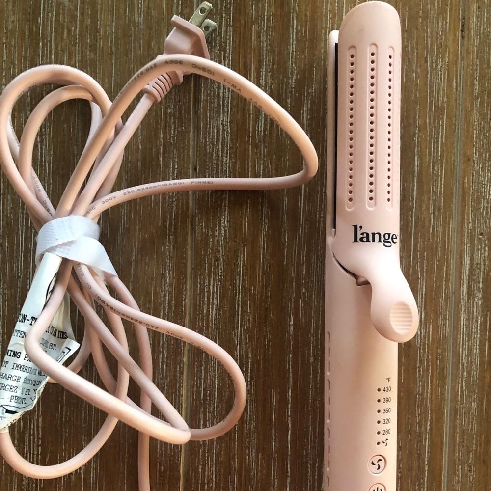 Lange duo airflow styling tool. Blush color, titanium plates for smooth styling.